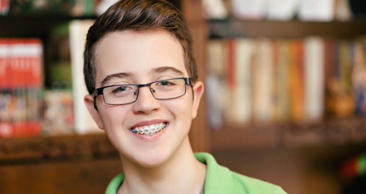teenage boy with glasses and braces smiling