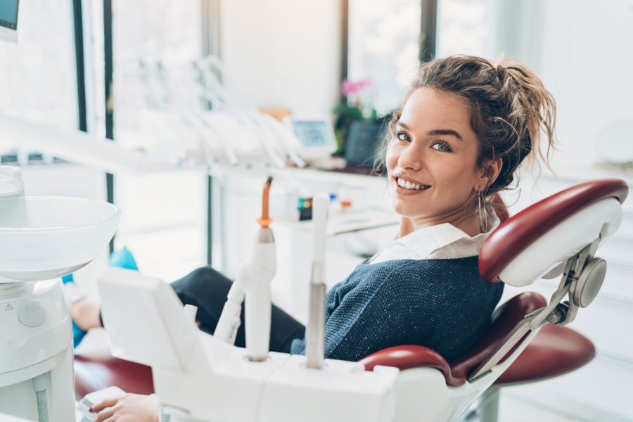 Brunette woman at the dentist in Fayetteville, AR to get a deep cleaning to treat gum disease