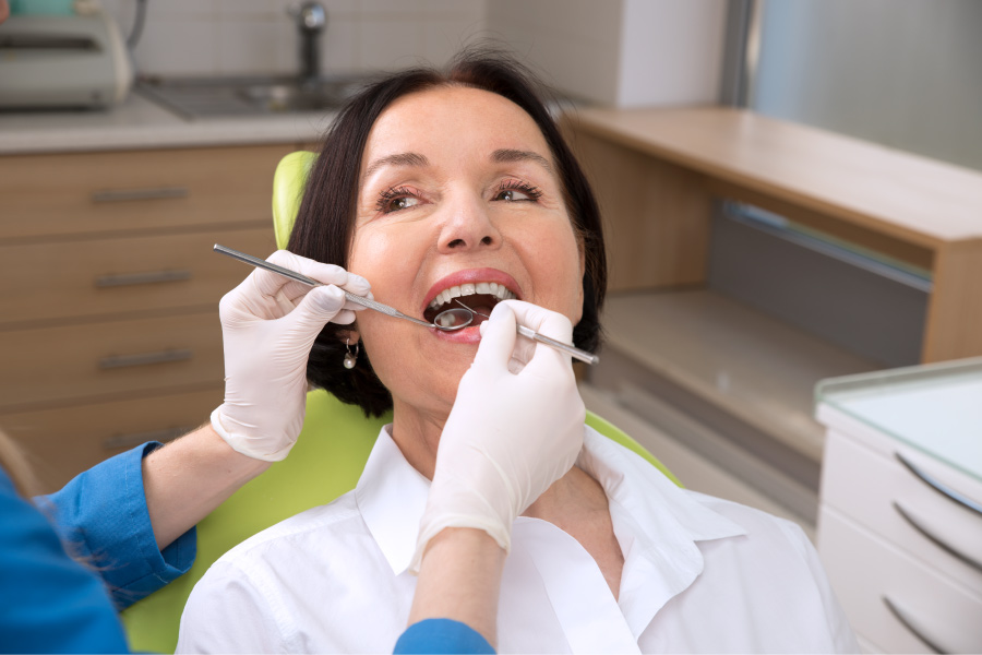 Brunette woman gets a dental cleaning & checkup at the dentist near Fayetteville, AR