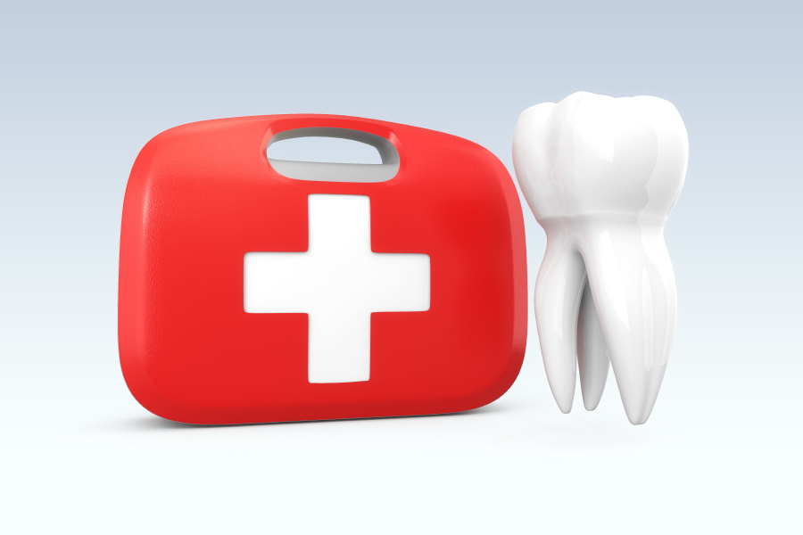 A red first aid kit next to a floating white tooth for a dental emergency