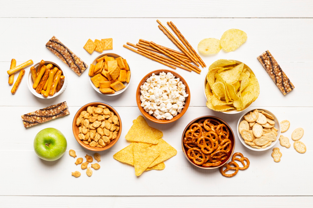 Aerial view of a variety of snacks on a white background